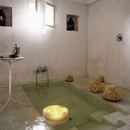 a room that has some candles in the floor and two pictures hanging on the wall