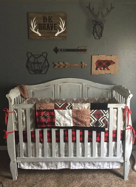 a baby crib in the corner of a room with antlers on the wall