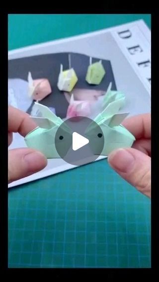 someone is holding up some origami pieces to show off their crafting skills