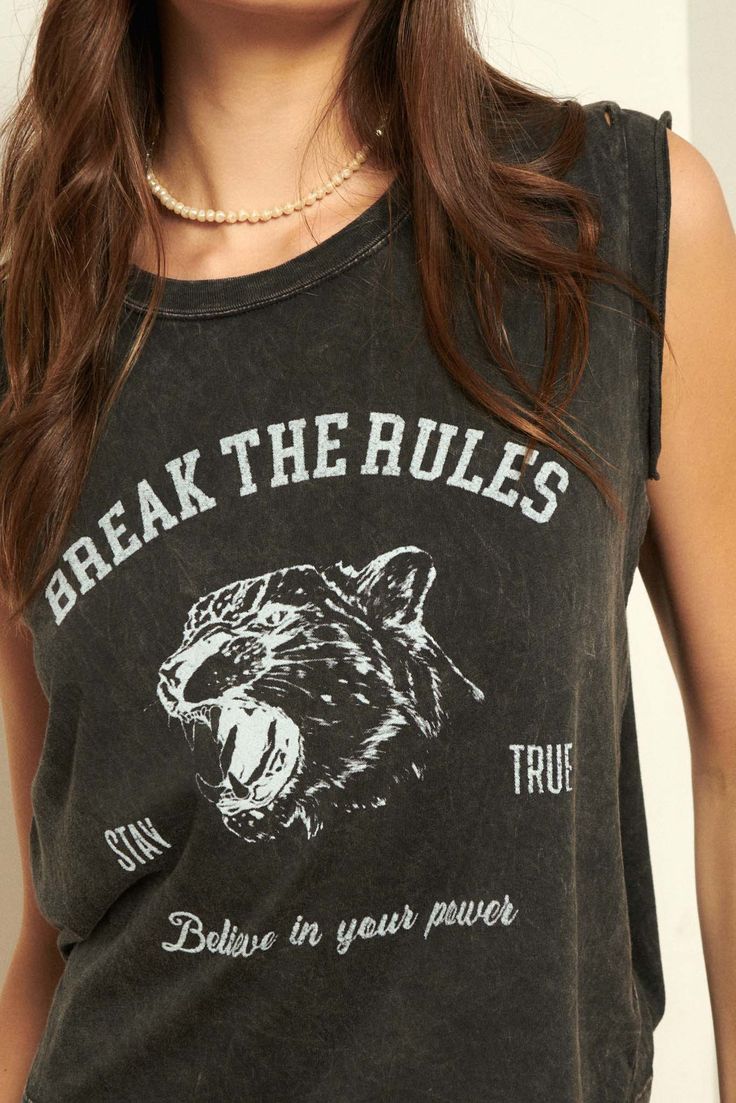 A mineral washed graphic tee with the following features: Vintage-style leopard graphic print with text that reads: "Break the Rules," "Stay True," and "Believe in Your Power". Cut-off sleeves with raw edge. Round neckline. Distressed detailing at neckline and hem. Relaxed fit. 100% Cotton. Imported top designed and printed in LA. Model wears size S. Edgy Sleeveless Graphic T-shirt, Edgy Sleeveless Graphic Print T-shirt, Rebellious Cotton Top With Graphic Print, Rebellious Cotton Tops With Graphic Print, Rebellious Cotton Graphic Print Tops, Grunge Crew Neck Tank Top With Letter Print, Trendy Graphic Print Crew Neck Tank Top, Rebellious Cotton T-shirt With Graphic Print, Crew Neck Graphic Print Tank Top