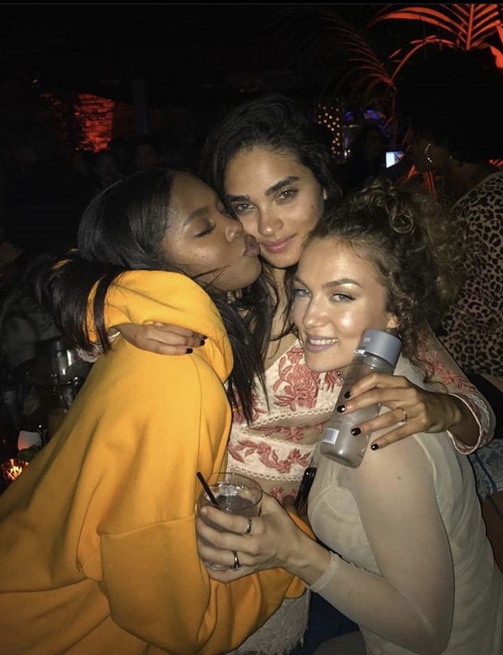 three women hugging each other at a party