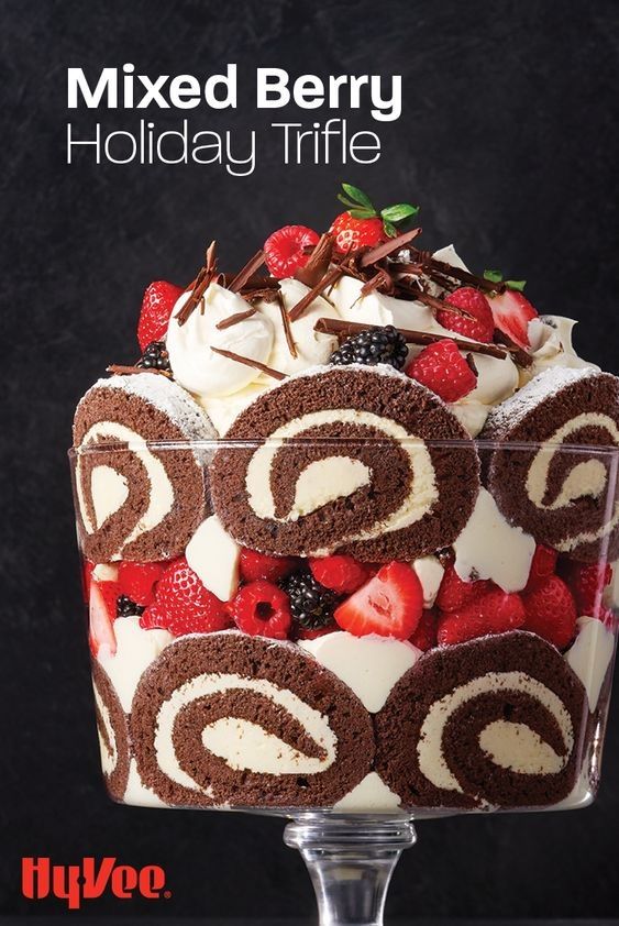 an advertisement for mixed berry holiday trifle with chocolate swirl and strawberries on top