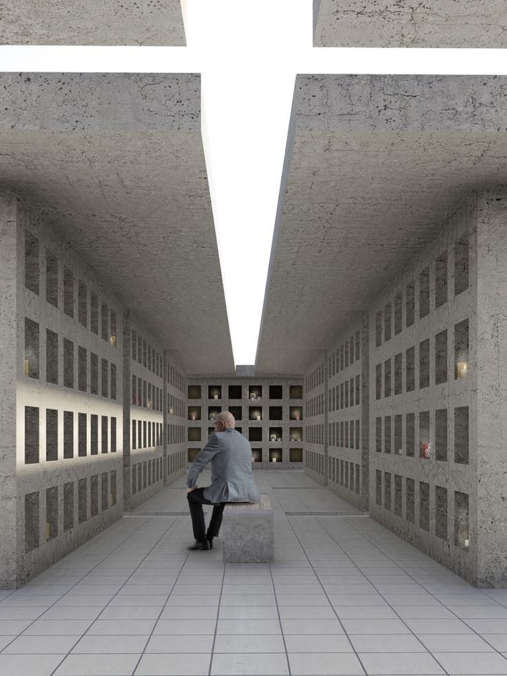 a man is sitting on a bench in a room with concrete walls and flooring