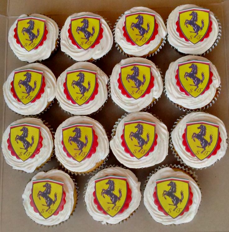 twelve cupcakes with frosting in the shape of ferrari logos