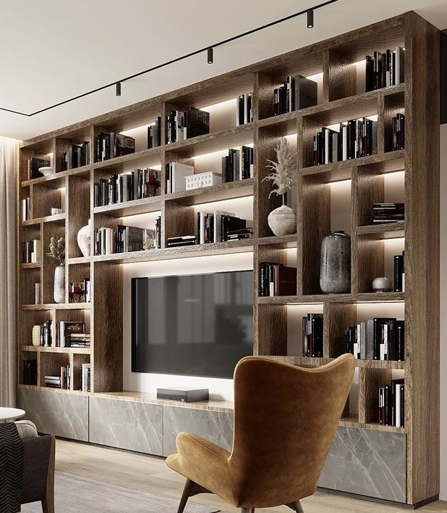 a living room filled with furniture and a large book shelf covered in lots of books