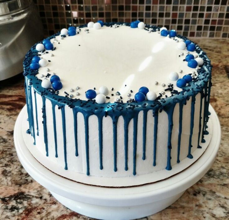 a blue and white cake sitting on top of a counter