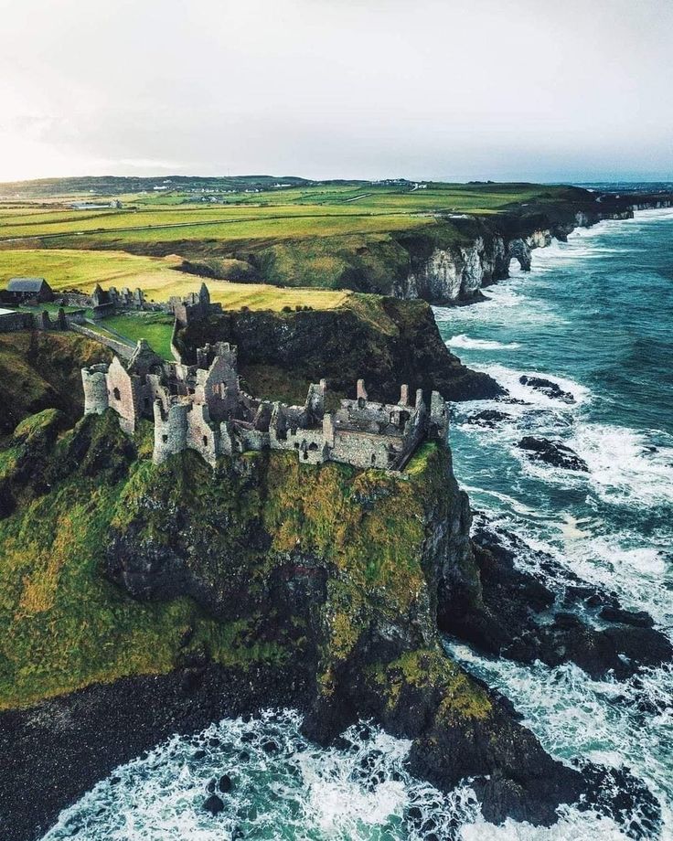 an aerial view of a castle near the ocean