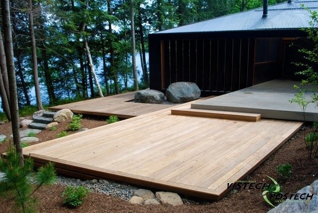 a wooden deck surrounded by rocks and trees