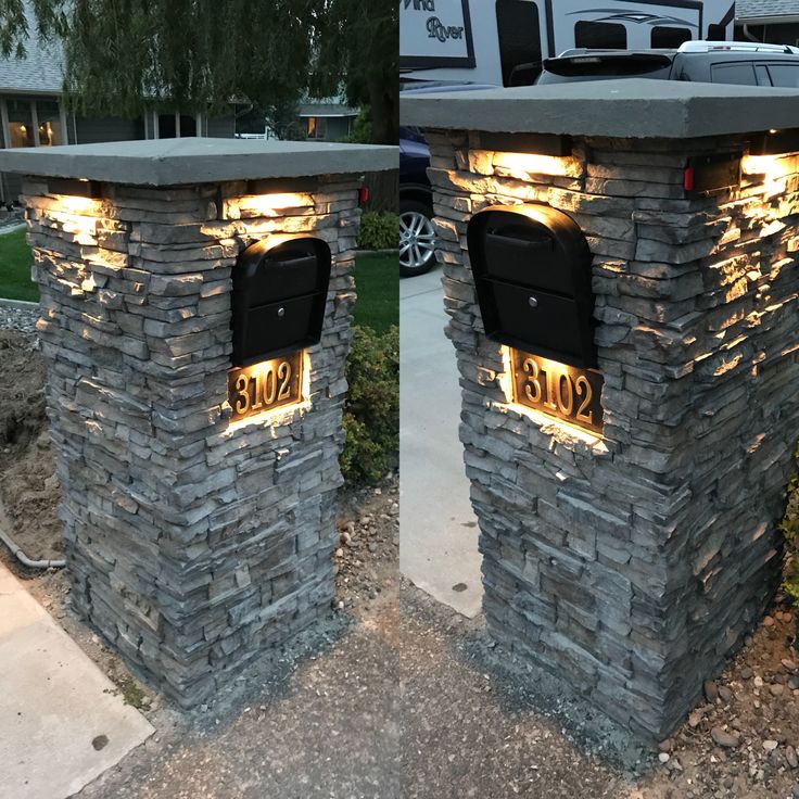 two mailboxes with lights on them are sitting in the middle of a driveway