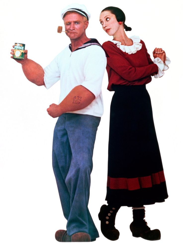 a man and woman standing next to each other while holding cans of canned food in their hands