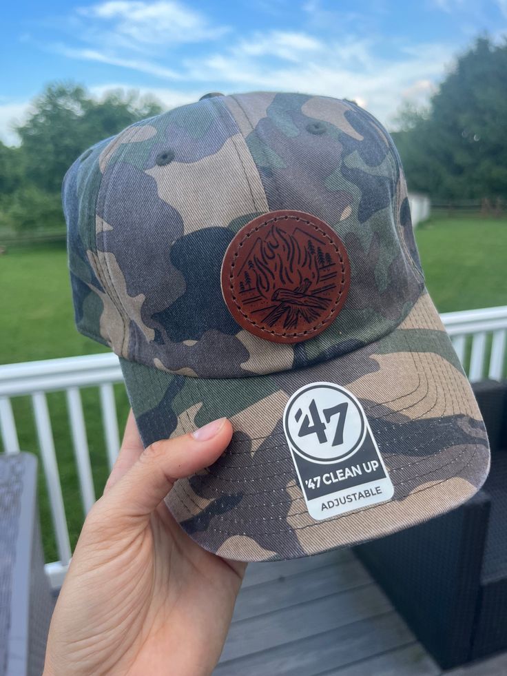 Our amazing bonfire design now on leather patches hand sewn onto these unstructured hats or known as dad caps. Hats feature a metal clasp to adjust to most head sizes. Choose from pine green or Camo in our other listing. Adjustable Trucker Hat With Patches For Outdoor, Outdoor Adjustable Trucker Hat With Patches, Outdoor Trucker Hat With Patches And Curved Brim, Adjustable Snapback Hat With Patches For Outdoor, Military Style Adjustable Dad Hat, Adjustable Curved Bill Hat For Camping, Adjustable Snapback Hat With Patches And Curved Brim, Adjustable Brown Baseball Cap For Camping, Brown Curved Brim Trucker Hat For Camping