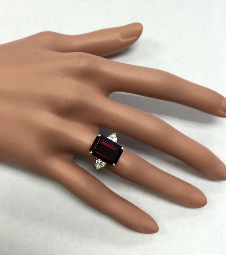 9.25 Carats Natural Impressive Red Garnet and Diamond 14K White Gold Ring Suggested Replacement Value $5000 Total Natural Red Garnet Weight is: 8.95 Carats (VVS) Red Garnet Measures: 13.8 x 9.96mm Natural Round Diamonds Weight: .30 Carats (color F-G / Clarity VS2-SI1) Ring total weight: 6.8 grams Disclaimer: all weights, measurements and colors are approximate and may vary slightly from the listed dimensions or as seen in the image. All pictures are magnified to show the smallest of details. Ple Red Ruby Ring With Vvs Clarity And Baguette Cut, Luxury Emerald Cut Aaa Quality Rings, Formal Garnet Gemstone Diamond Ring, Luxury Emerald Cut Rings With Aaa Quality, Luxury Emerald Cut Rings Of Aaa Quality, Luxury Red Diamond Ring With Accent Stones, Luxury Red Diamond Ring With Polished Finish, Formal Garnet Diamond Ring With Accent Stones, Red Formal Rings With Accent Stones