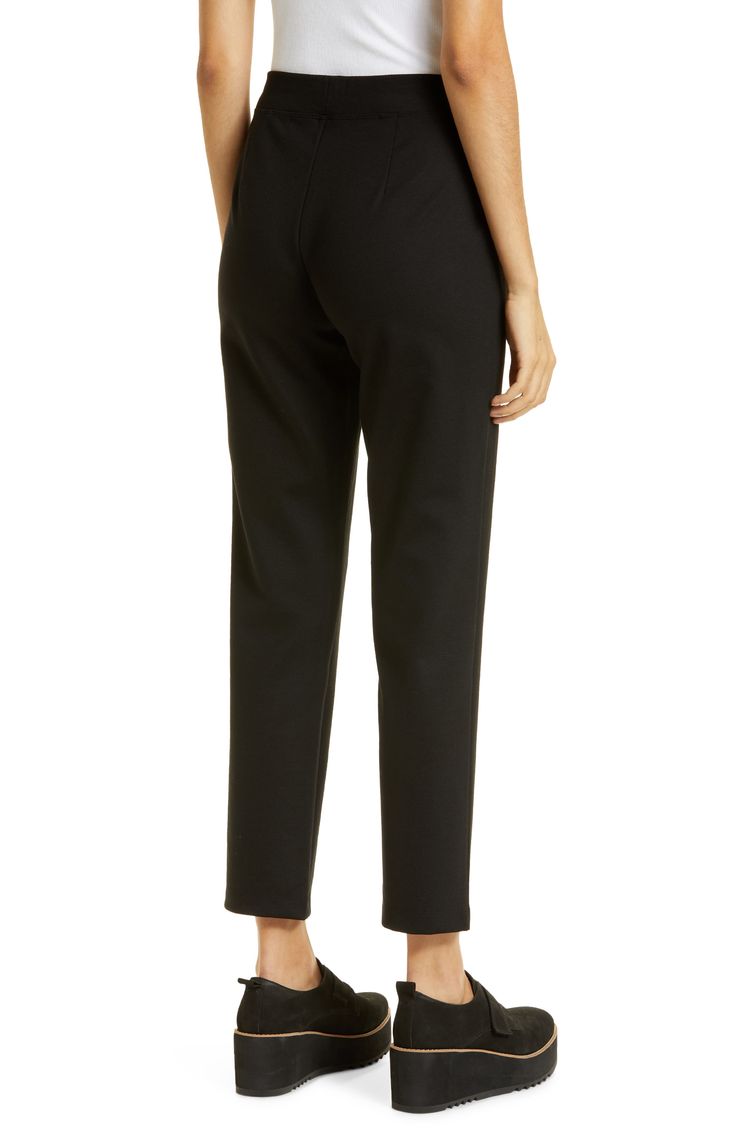 Elevate your comfort level in these work-to-play pants designed in a stretch knit with an easy elastic waist. 29 1/2" inseam; 13" leg opening; 10 1/2" front rise; 16" back rise (size Medium) 68% Tencel® lyocell, 29% nylon, 3% spandex Tencel lyocell is a sustainably produced fiber made with closed-loop processing Dry clean or machine wash, line dry Imported This brand has B Corp certification, representing business practices with emphasis on social and environmental performance, accountability an Black Pants With Elastic Side Panels For Work, Black Workwear Pants With Elastic Side Panels, Comfort Stretch Tapered Leg Pants For Workwear, Comfort Stretch Tapered Leg Work Pants, Black Bottoms With Elastic Side Panels For Work, Comfort Stretch Cropped Leg Pants For Workwear, Comfort Stretch Cropped Pants For Work, Workwear Cropped Leg Pull-on Pants, Business Casual Cropped Leg Pull-on Pants