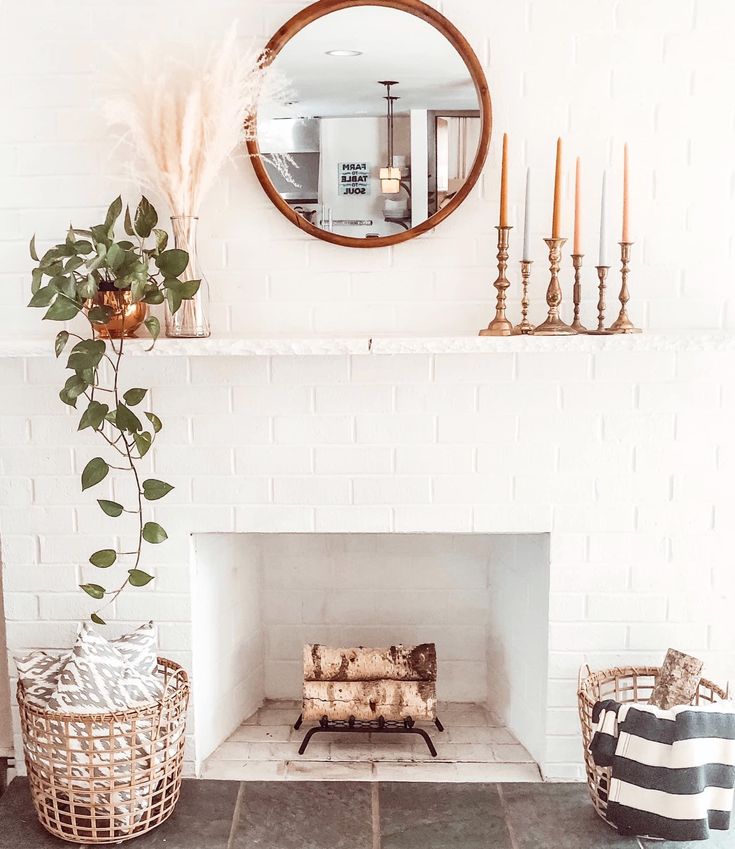 a living room with a fire place and mirror on the wall