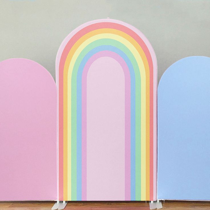 three pastel colored arch covers stand next to each other on a wood floor with text overlay that reads printed custom arch cover stand