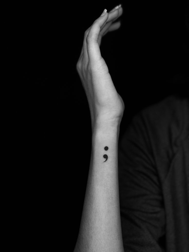 a person with a small tattoo on their wrist