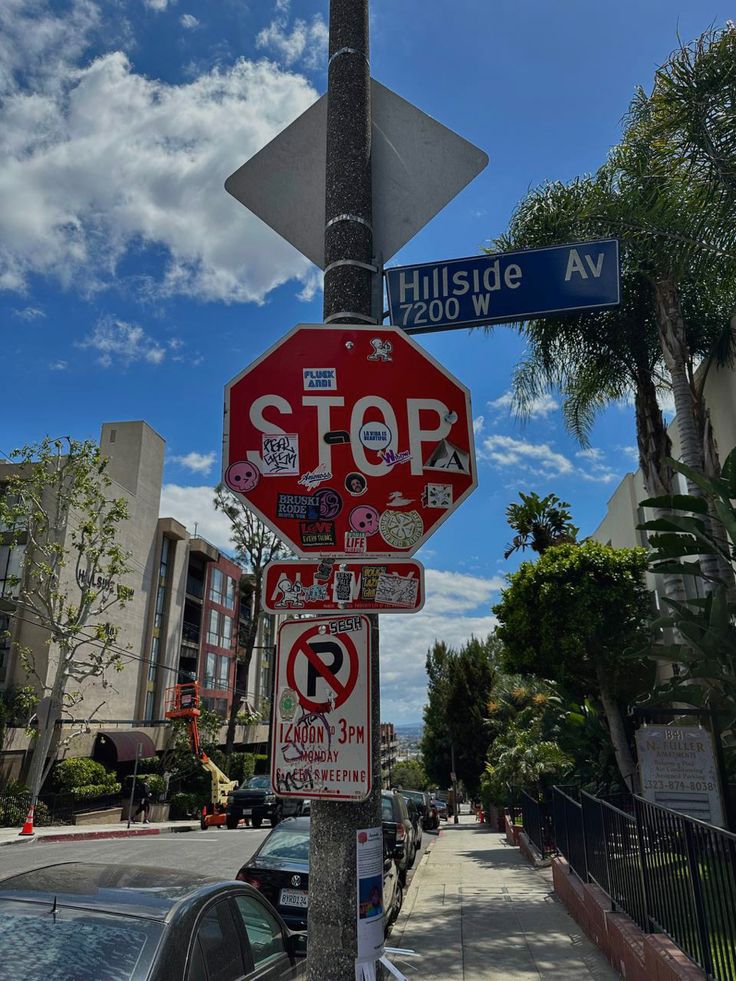 a stop sign with several stickers on it