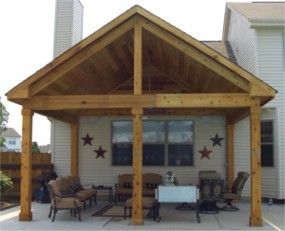 a covered patio area with chairs and tables