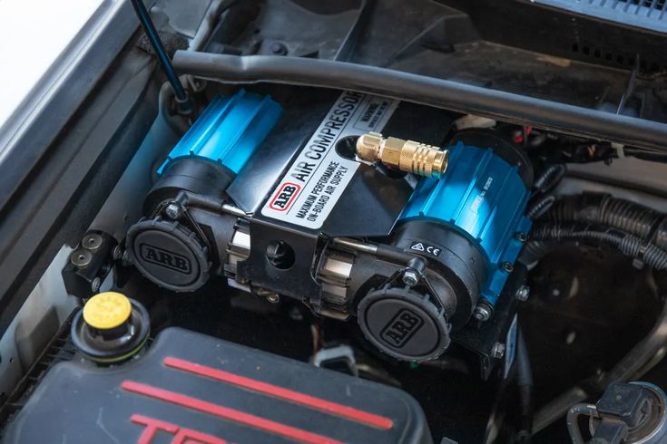 the engine compartment of a car with blue and red paint on it's hood