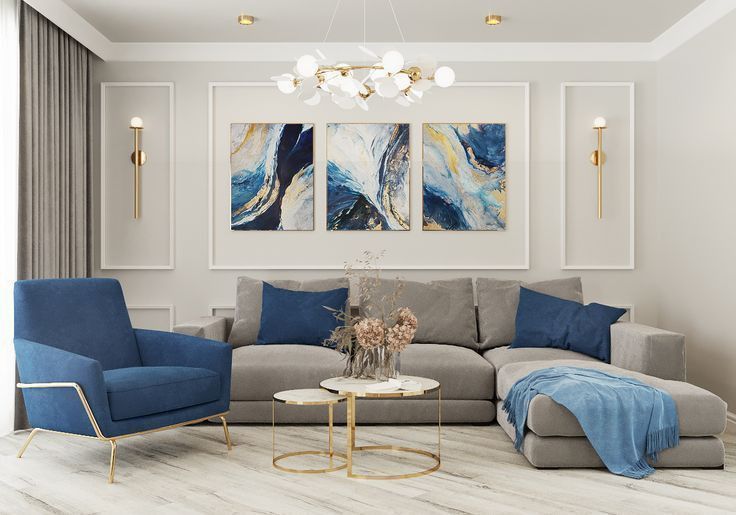 a living room with blue and grey furniture in it's centerpiece, two paintings on the wall