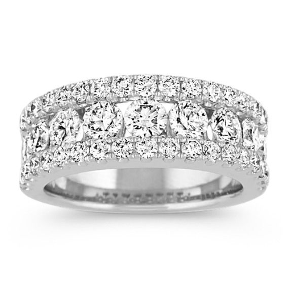 This classic wedding band features 47 pavé and channel-set round diamonds at approximately 2.20 carats total weight. Each magnificent gemstone has been hand-matched for exceptional beauty and sparkle. The quality 14 karat white gold setting measures an elegant 7.5mm at the center. Luxury Diamond Ring With Birthstone And Round Band, Luxury Bands With Diamond Accents And Round Cut, Luxury Diamond Ring With Diamond Accents And Round Band, Luxury Diamond Stackable Rings With Halo Setting, Luxury Platinum Stackable Rings With Round Band, Classic Luxury Bands With Single-cut Diamonds, Luxury Elegant Bands With Pave Setting, Luxury Diamond Cut Bands For Marriage, Luxury Wedding Bands With Single Cut Diamonds