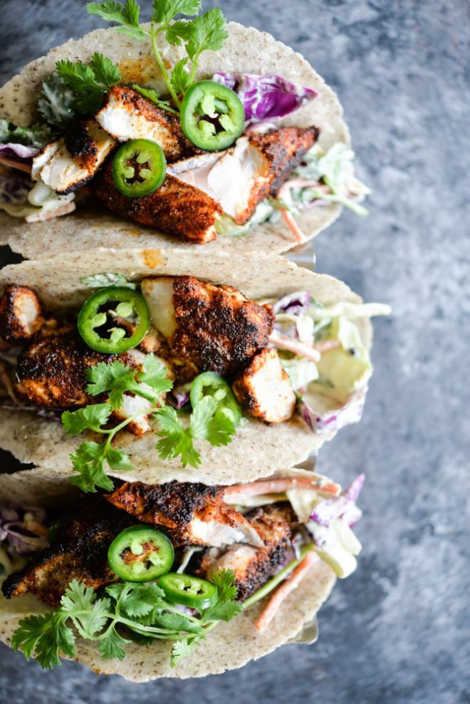 three tacos with chicken, lettuce and jalapenos on them