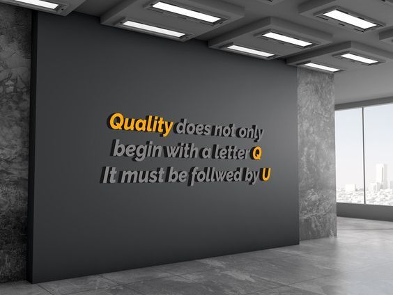 an empty room with a large sign on the wall that says quality doesn't only begin with letter o it must be followed by