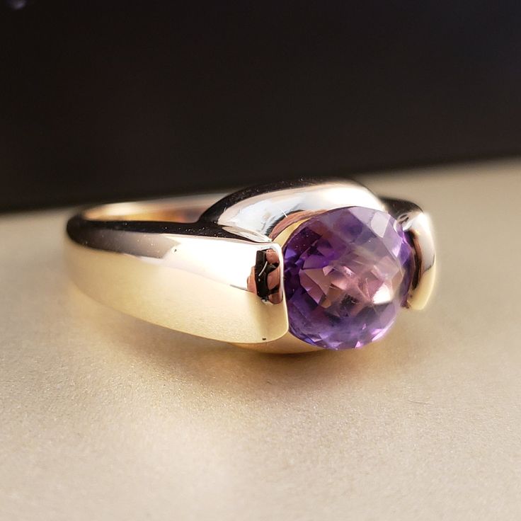 "\"Previously Loved, Not New\" Vintage Amethyst Ring, Featuring a Genuine Amethyst center (*Price of the ring is really gold only. The center is pretty scratched on the surface.*) This Genuine Purple Amethyst center stone is a checkered board cut oval shape. 14k Yellow Gold setting with 2 heavy bars. **Ring size: 6.25 **Amethyst is February's Birthstone, AND 2018 color of the year. This item can be sized up or down 2 sizes for an additional $30.00 Please feel free to contact me anytime, if you h Vintage Amethyst Ring, Checkered Board, Amethyst Rings, Amethyst Ring Vintage, Ring Purple, Lapis Ring, Rings Vintage, Yellow Gold Setting, Purple Band