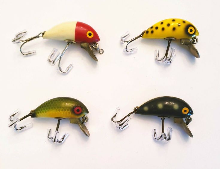 four different types of fishing lures on hooks