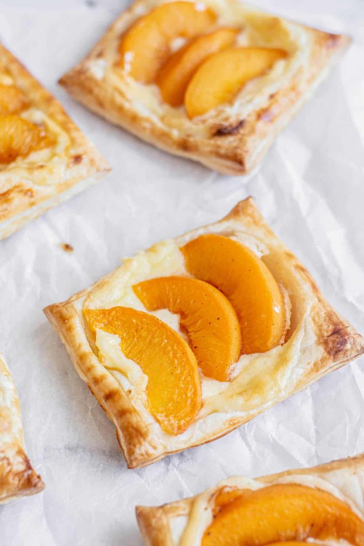 small pieces of pastry with sliced peaches on top