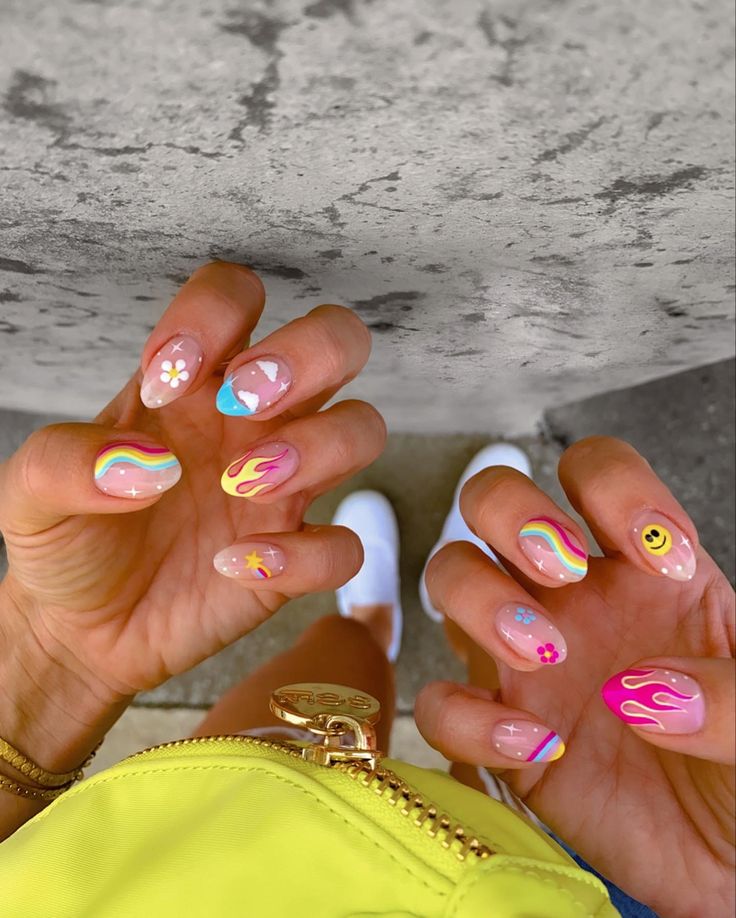 Music festival nails with bright colors, smileys, flames & stars Cool Rave Nails, Simple Summer Nail Art 2024, Nails For Festival Summer, Rave Festival Nails, Almond Festival Nails, Crazy Cool Nail Designs, Crazy Color Nails, Coachella 2024 Nails, Nails For Music Festival