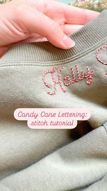 someone is stitching onto the back of a sweater with candy cane lettering on it