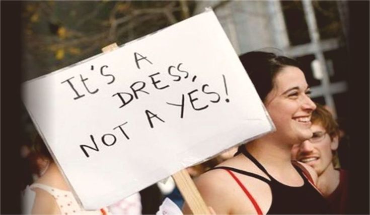 a woman holding a sign that says it's a dress, not a yes