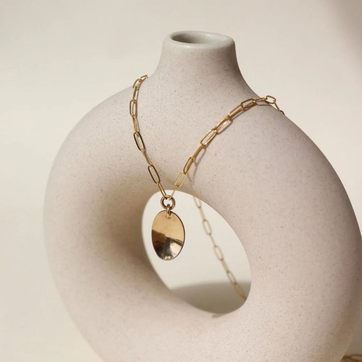 DescriptionThe Olivia Necklace features: Hypoallergenic, waterproof, and nickel free Simple and versatile Minimalistic look Made in the USA Size14" chain, pendant measures 0.8". Material14k gold fill About Token JewelryModern + minimal jewelry with a timeless feel, founded in 2005 by Sarah Willger. Each piece of Token Jewelry is handmade from start to finish, using sterling silver, 14k yellow and rose gold fill and natural gemstones. Sarah draws inspiration for her designs through the exploratio Gold Modern Charm Necklace For Everyday, Modern Gold Charm Necklace For Everyday, Modern Gold Charm Necklace With Delicate Chain, Minimalist Silver Charm Necklace With Gold Chain, Minimalist Cable Chain Jewelry For Everyday, Modern Brass Necklace With Delicate Chain, Everyday Brass Necklace With Paperclip Chain, Everyday Brass Delicate Chain Necklace, Everyday Brass Necklace With Cable Chain