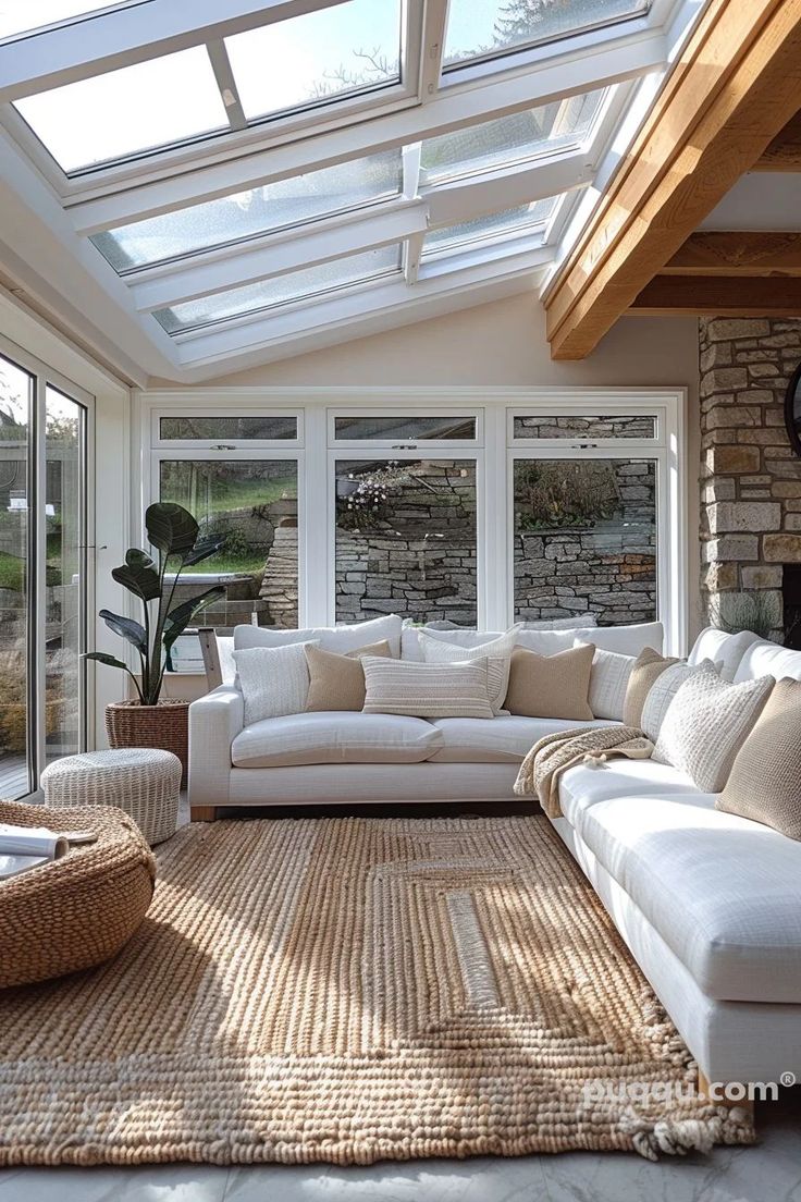 a living room filled with lots of furniture and windows