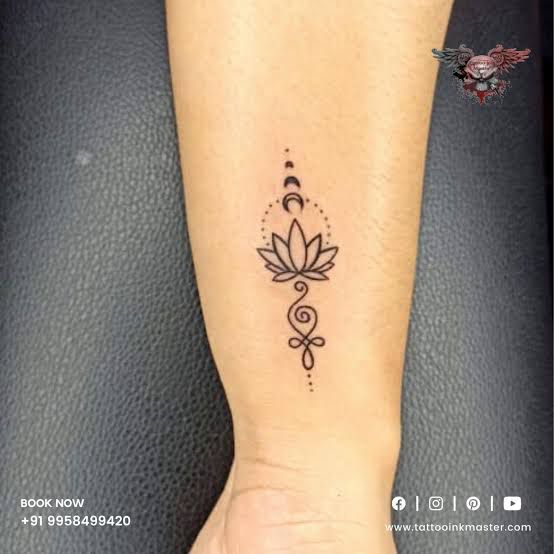 a woman's arm with a tattoo on it that has a flower and leaves