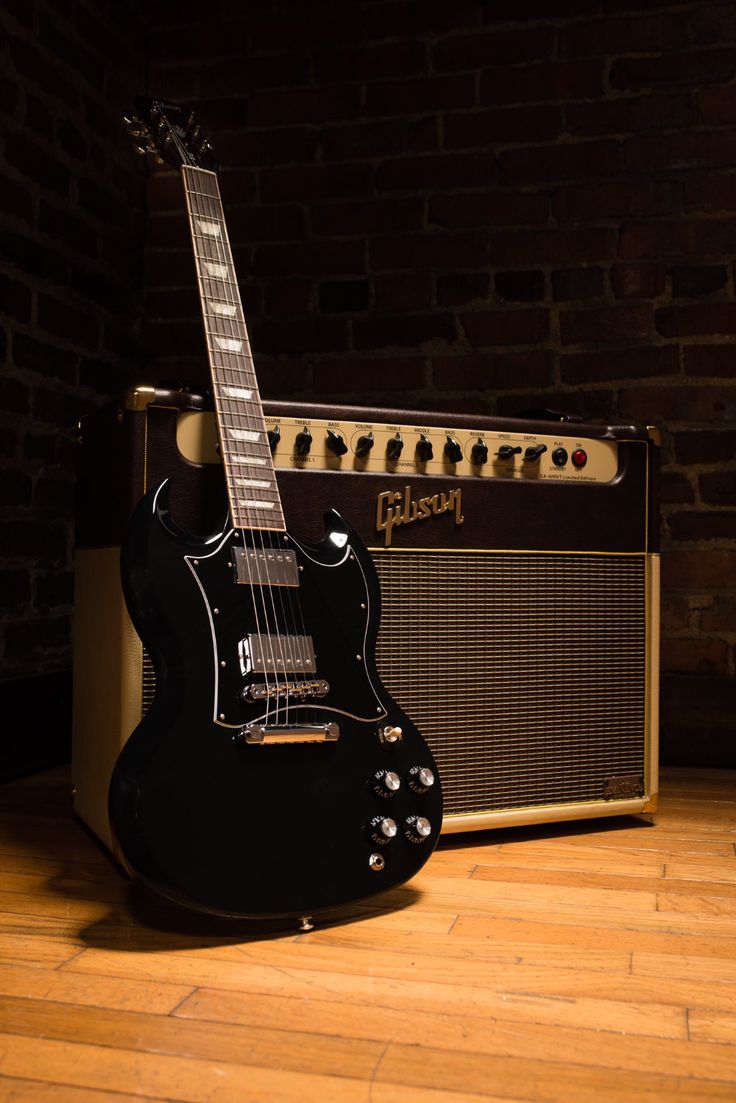 an electric guitar sitting on top of a wooden floor