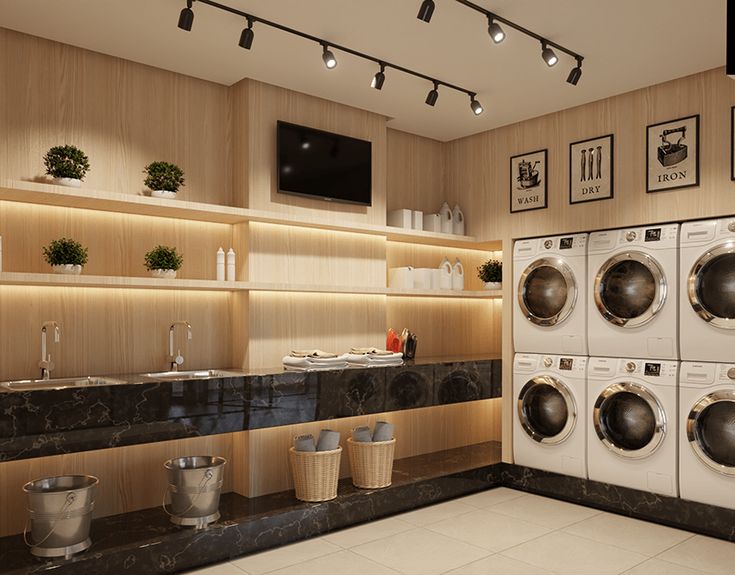 a laundry room with washers and dryers in it