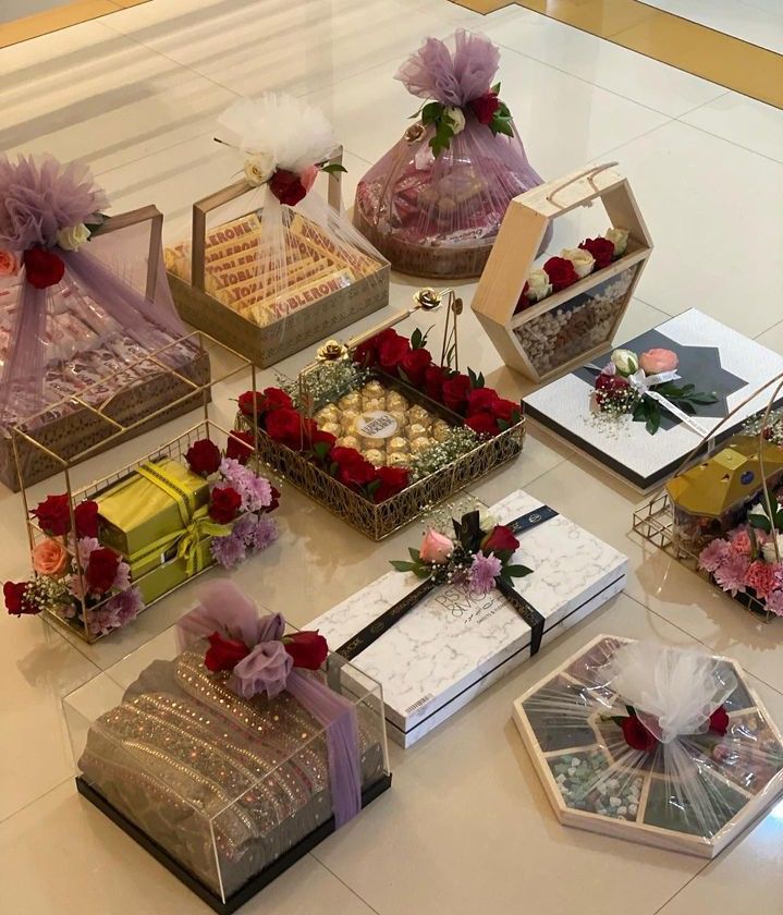 many different types of boxes with flowers and ribbons on the floor next to each other