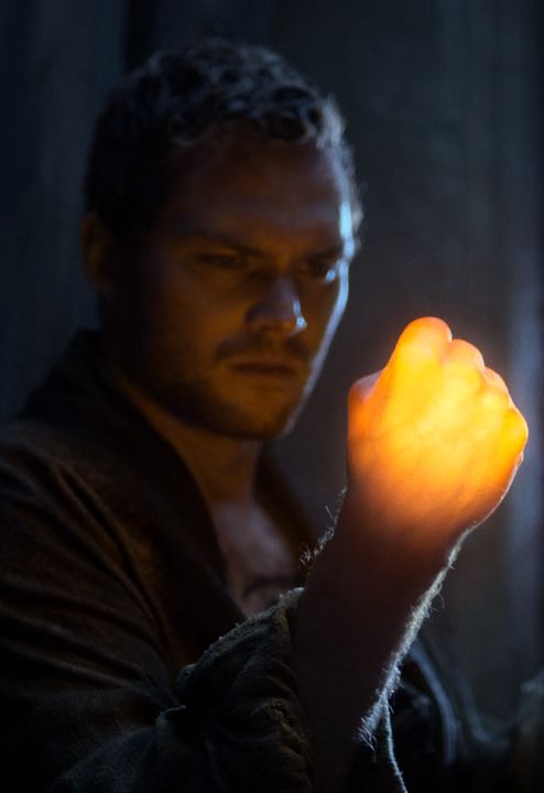 a man holding a glowing orange object in his hand