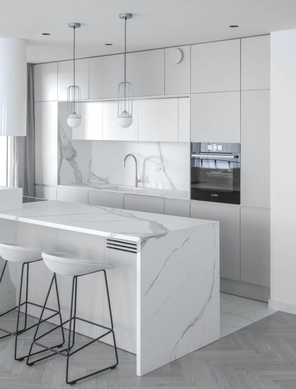 a white kitchen with marble counter tops and stools