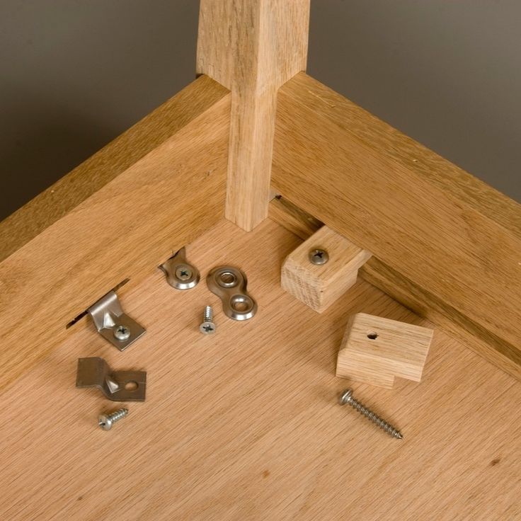 woodworking tools and screws are laying on the floor next to a piece of wood