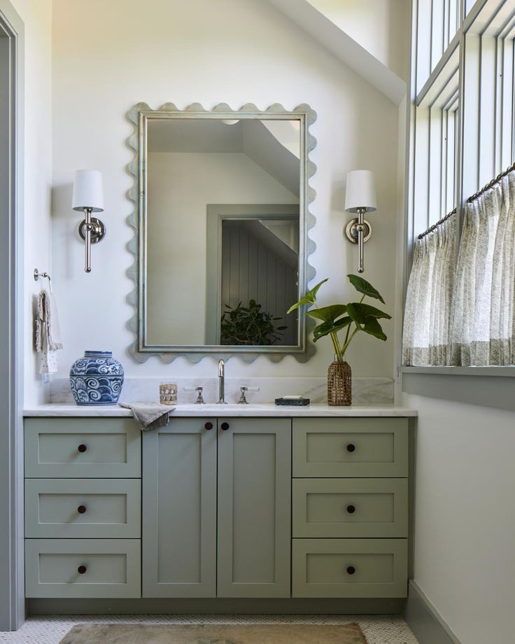 a bathroom with two sinks and a large mirror