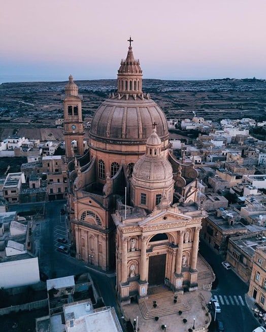 an aerial view of a large building in the city