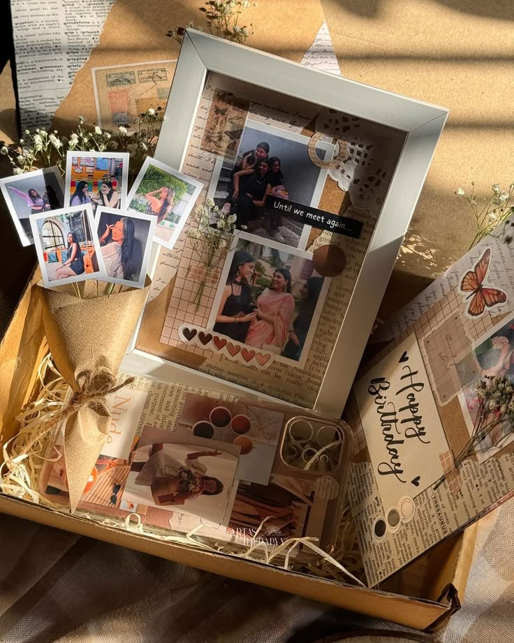 a box filled with pictures and cards on top of a table