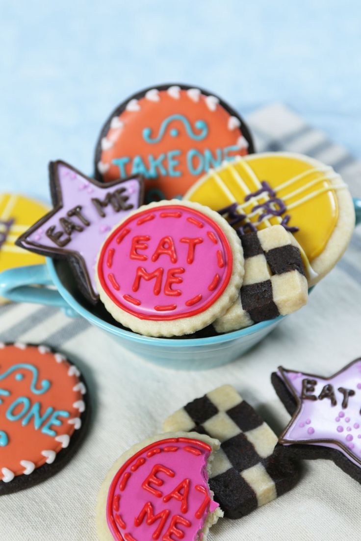 some decorated cookies are in a bowl on a table