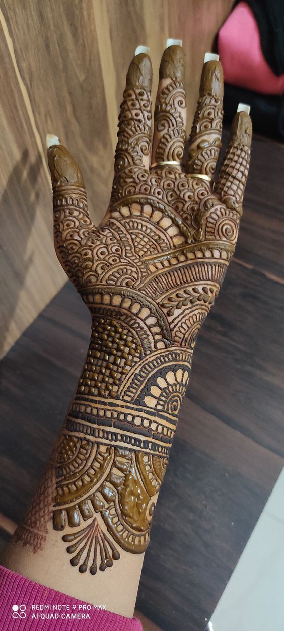 the hand is decorated with intricate designs