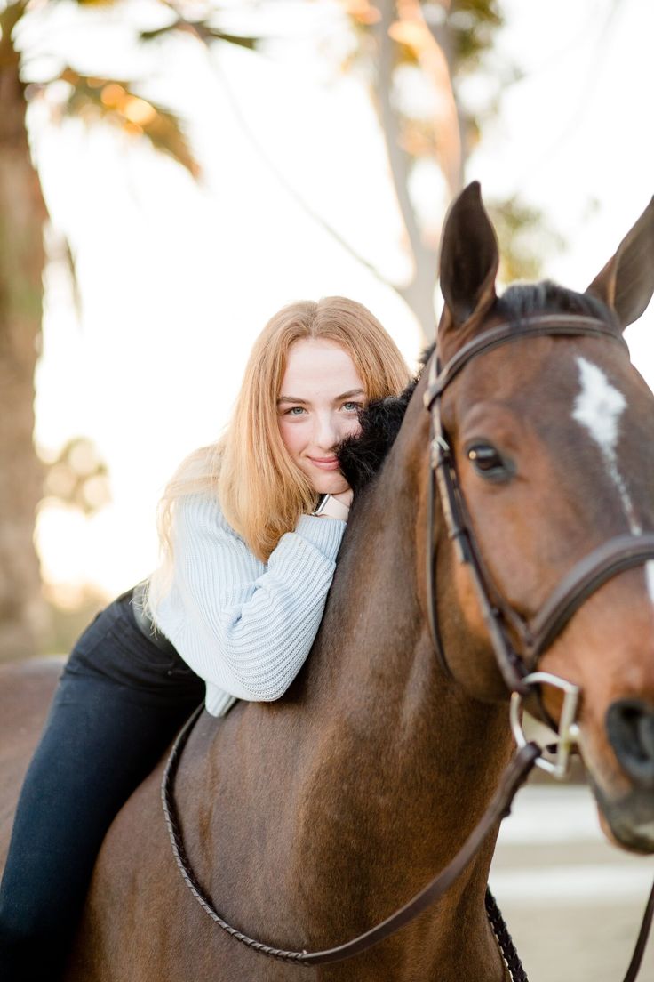 a woman riding on the back of a brown horse