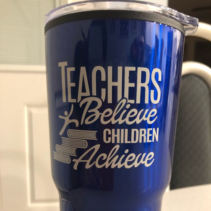 a blue coffee cup with the words teachers believe children achieve on it sitting on a table