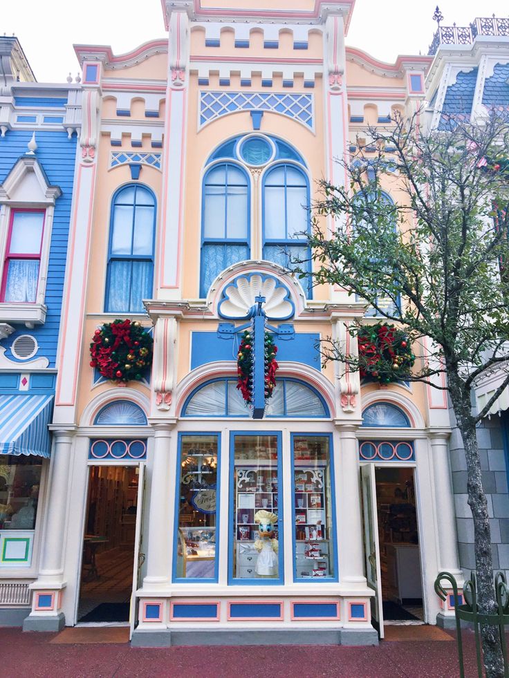 the front of a building with many windows and decorations